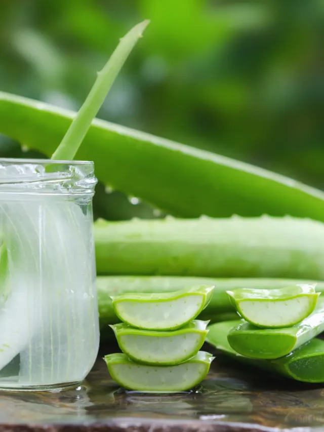 aloe vera juice in glass on stone background